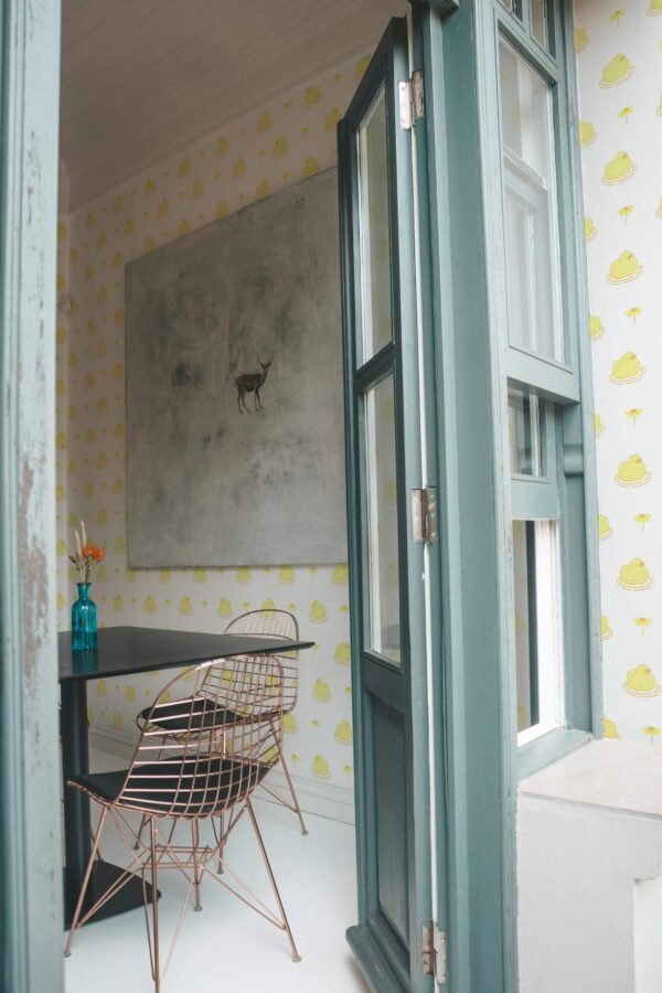 Minimal coastal style cafe decorated with Kawaii ducks peel and stick wallpaper