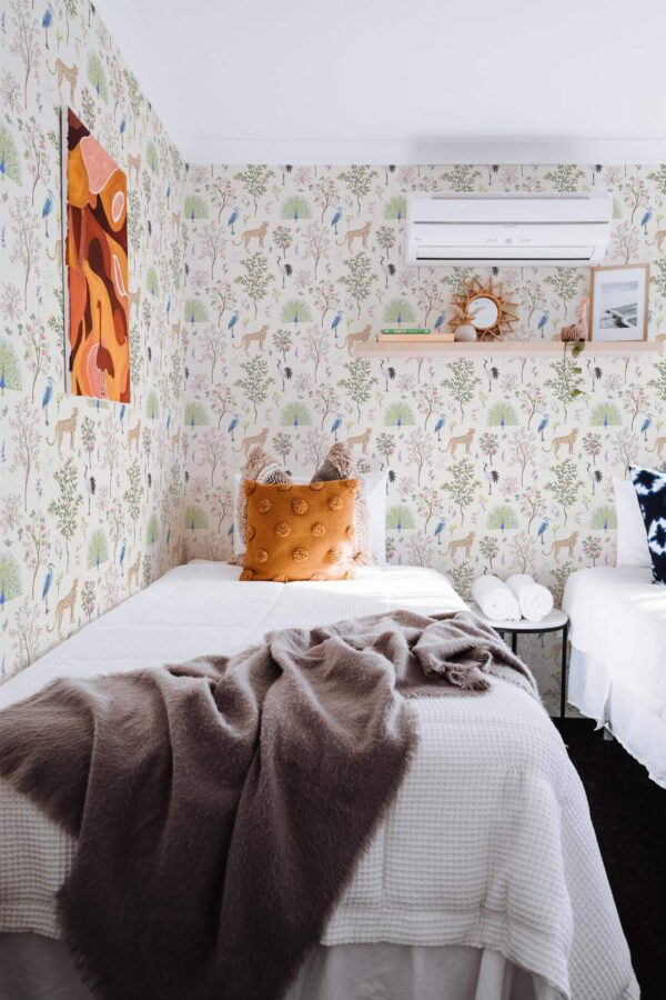 Boho style bedroom decorated with Menagerie peel and stick wallpaper
