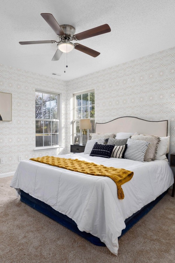 Eastern European style bedroom decorated with Moroccan boho peel and stick wallpaper