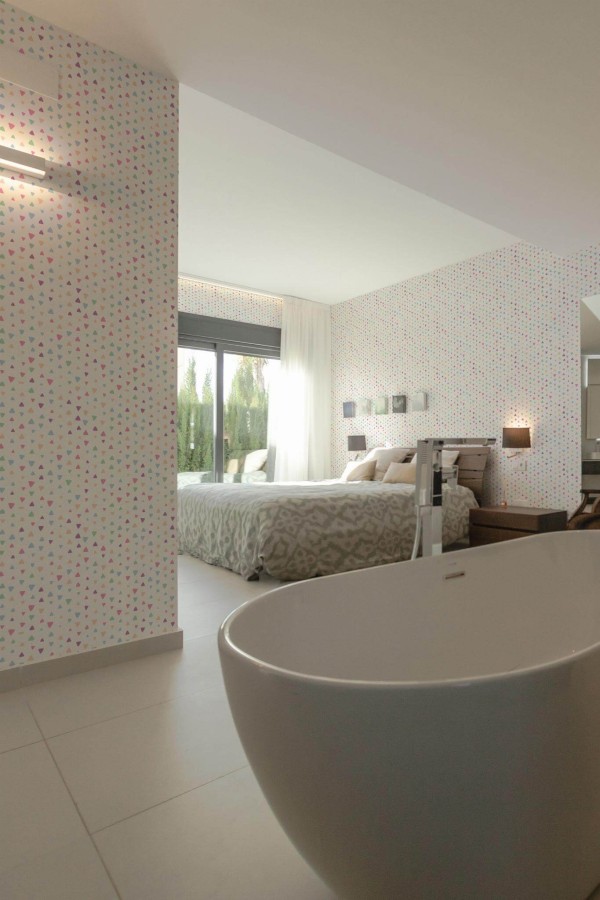 Modern style bedroom with open bathroom decorated with Multicolor Triangles peel and stick wallpaper