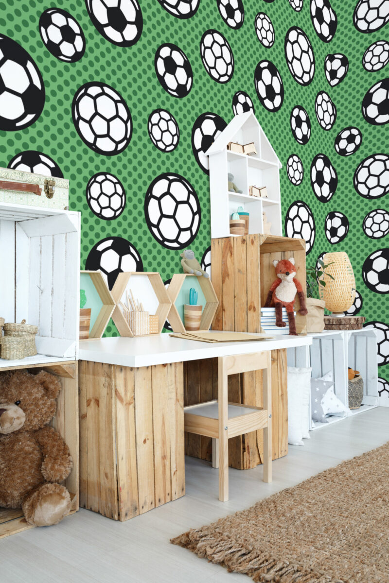 Football Frenzy Wall Mural with scattered footballs in various sizes on a green background, ideal for gyms, boys’ rooms, and playful game spaces.