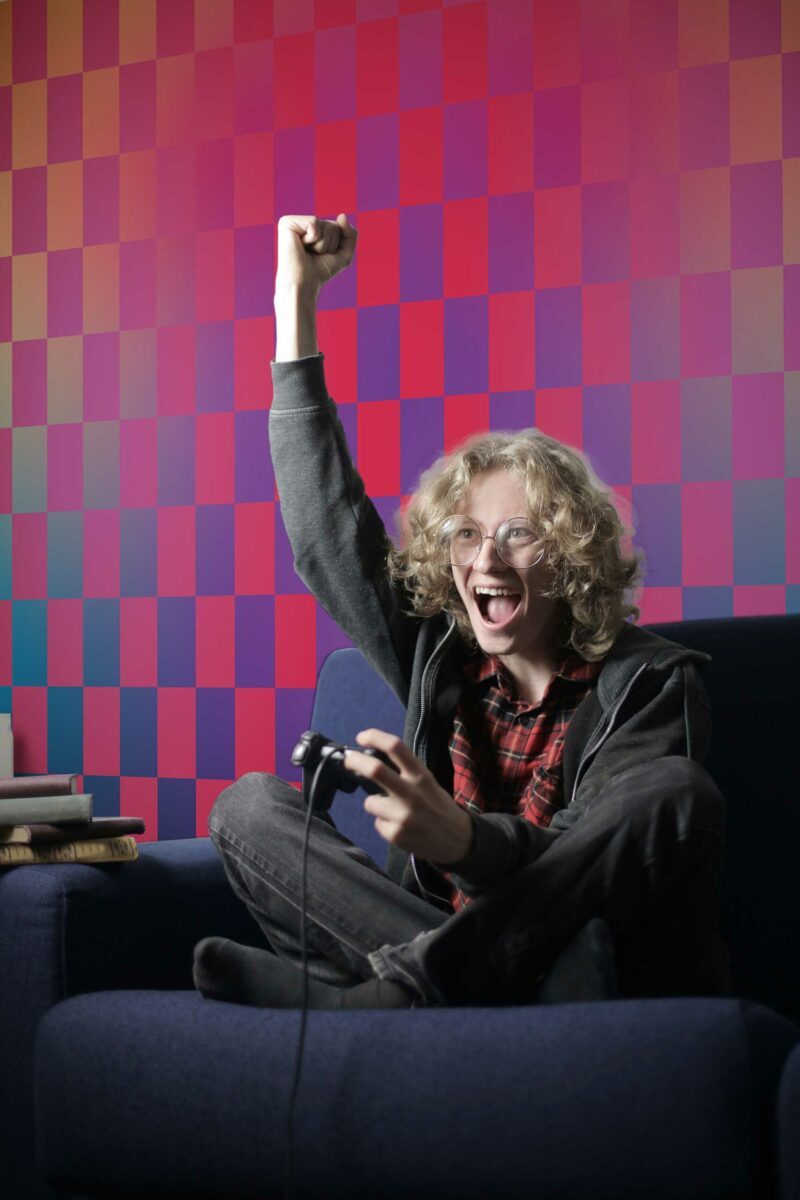 Vibrant Gradient Artistry wall mural with a bold pink checkered pattern and gradient colors, ideal for game rooms and modern offices.