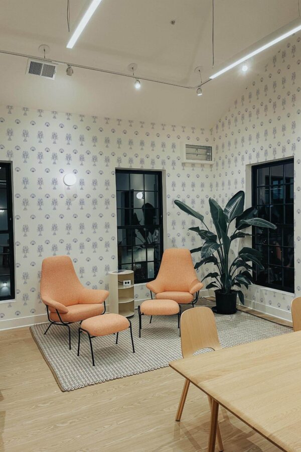 Minimal style living room decorated with Nautical lobster peel and stick wallpaper and mid-century style chairs
