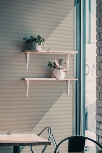 Industrial style cafe decorated with Neutral striped peel and stick wallpaper