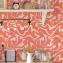 Orange groovy wallpaper pattern featuring funky curves and vibrant hues, perfect for accent walls. In this modern kitchen, the design adds a bold, contemporary twist that energizes the space while maintaining a playful and sophisticated aesthetic.