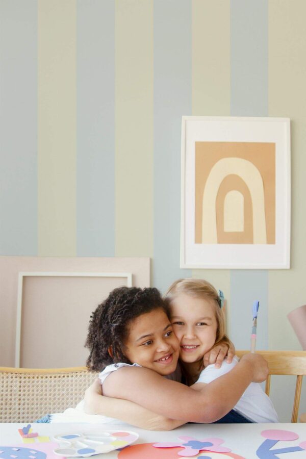 Boho style kids playroom decorated with Pastel striped peel and stick wallpaper
