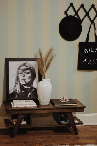 Rustic farmhouse style entryway decorated with Pastel striped peel and stick wallpaper