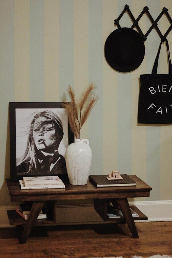 Rustic farmhouse style entryway decorated with Pastel striped peel and stick wallpaper
