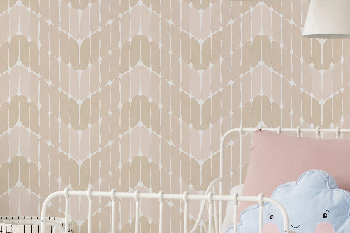 Soft pink and beige paintstroke wallpaper in a kids' bedroom with a white metal bed and pastel cushions – peel and stick, removable wallpaper.