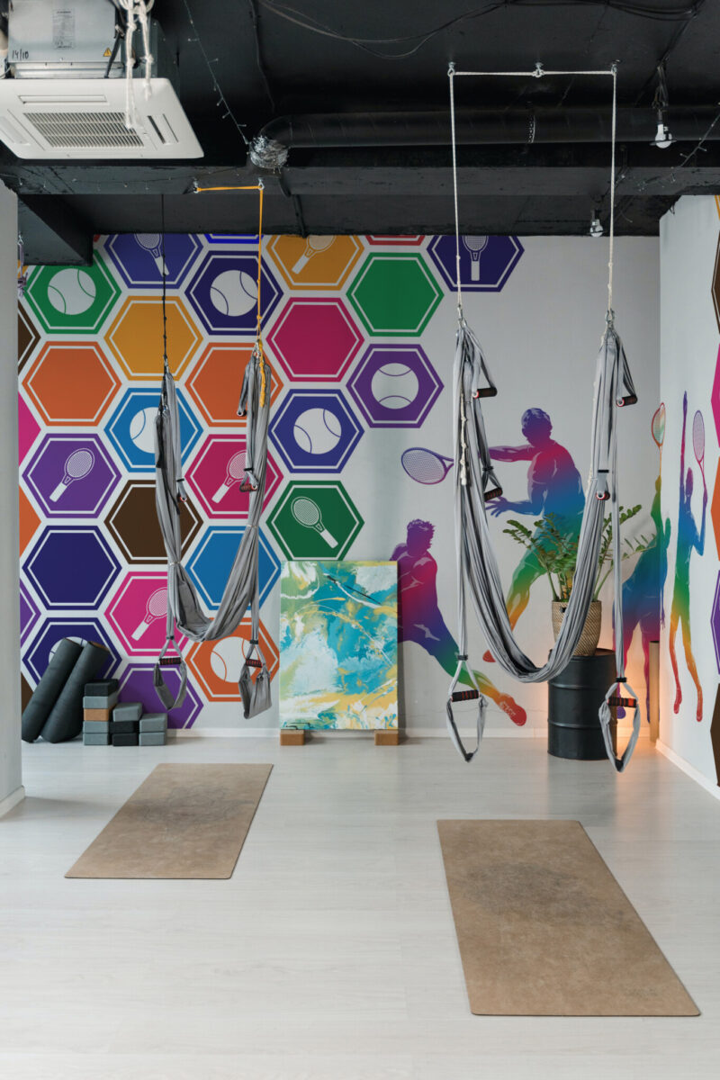 Colorful Dynamic Tennis Pictograms Wall Mural featuring abstract tennis figures and shapes on a white background, ideal for gym walls and fitness spaces.