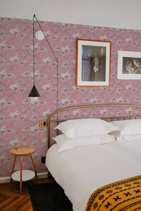 Minimal boho style bedroom decorated with Pink and white tropical floral peel and stick wallpaper