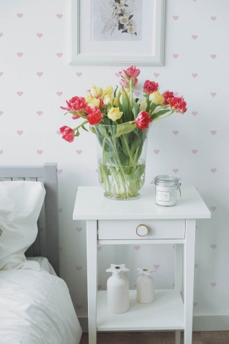 Minimalist pink heart wallpaper featuring small, delicate hearts scattered across a white background. This playful design brings warmth and joy to any room. The soft pink hearts offer a charming aesthetic that complements a variety of interior styles. Perfect for spaces like bedrooms or nurseries, this design creates a cozy and welcoming atmosphere. This wallpaper is color-changing, allowing you to customize the heart color to match your decor. The Fancy Walls peel and stick or non-pasted wallpaper is made from eco-friendly materials, printed with GreenGuard Gold certified inks for vibrant colors and safe indoor air quality.