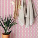Boho style bathroom decorated with Pink waves peel and stick wallpaper