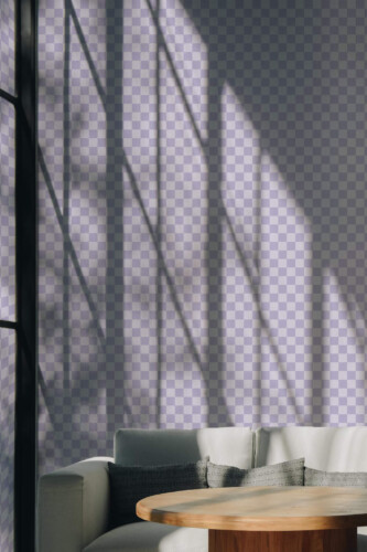 Pastel Purple Grid Wallpaper with a subtle lilac check pattern, styled in a sunlit modern living room featuring a neutral corner sofa and round wooden coffee table. The soft purple squares add an airy, contemporary accent to the space.
