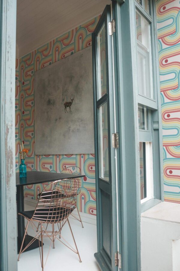 Minimal coastal style cafe decorated with Rainbow peel and stick wallpaper