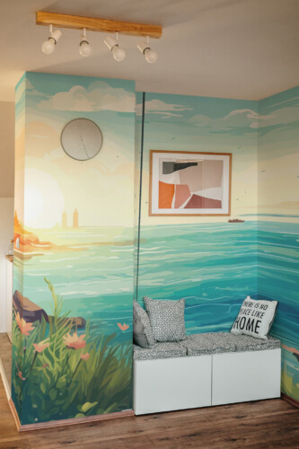 Peaceful Blue Beach With Boat Wall Mural with a sailboat on calm blue water, golden sunset sky, and distant mountains, perfect for living rooms, coastal homes, or serene accent walls.