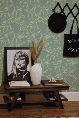Rustic farmhouse style entryway decorated with Sage leaves peel and stick wallpaper