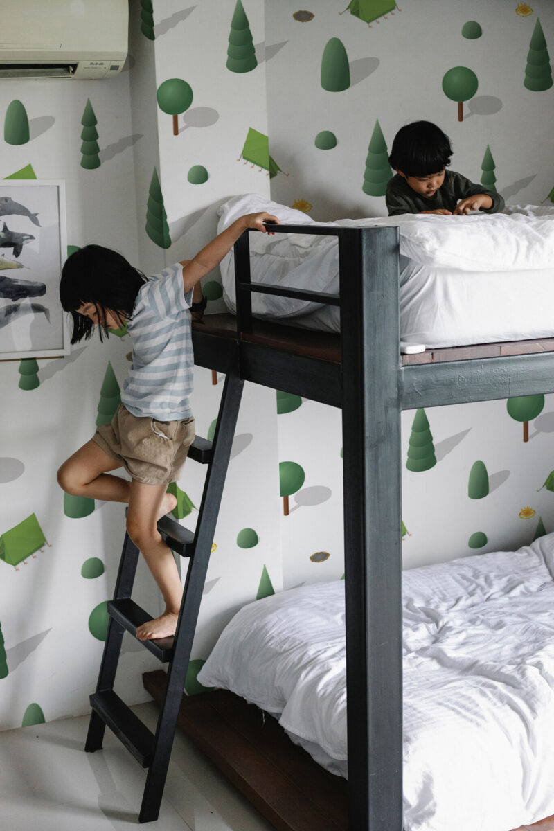Lush Isometric Camp wall mural with green and white isometric forest and tent design, perfect for kids' rooms or playful interiors.