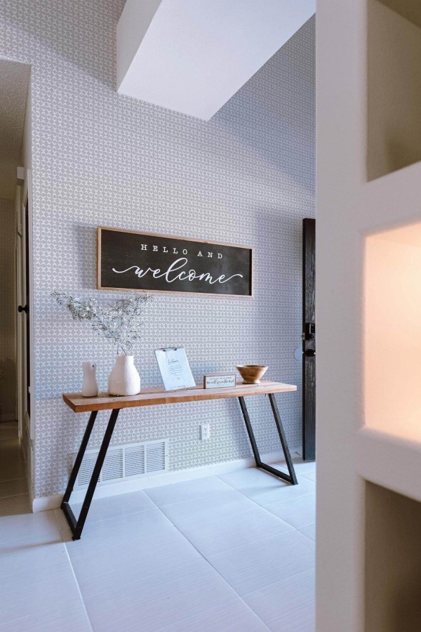 Minimal farmhouse style entryway decorated with Small link pattern peel and stick wallpaper