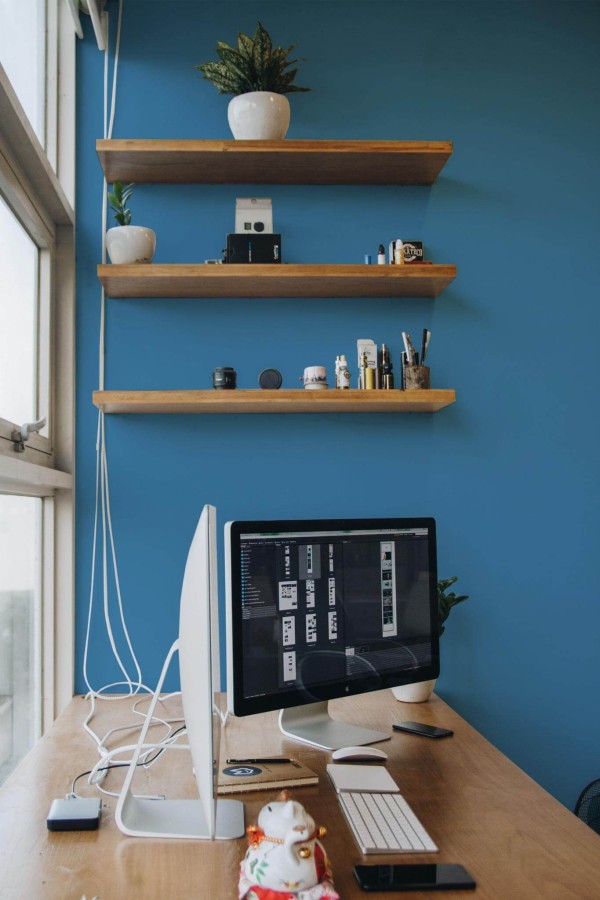 Mid-century rustic style office decorated with Solid bright blue peel and stick wallpaper