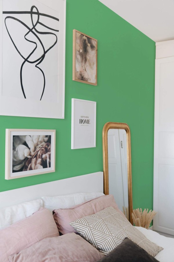 Bohemian style bedroom decorated with Solid emerald green peel and stick wallpaper