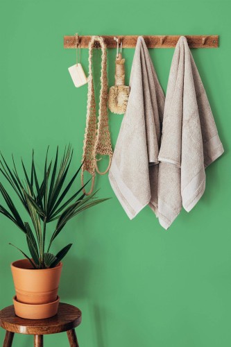 Boho style bathroom decorated with Solid emerald green peel and stick wallpaper