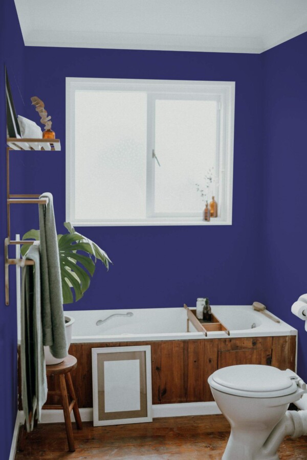 Boho farmhouse style bathroom decorated with Solid navy blue peel and stick wallpaper