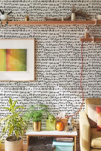Southwestern style living room decorated with Splashed peel and stick wallpaper