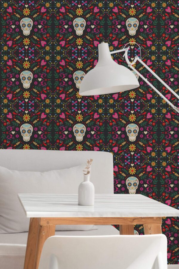 Sugar skull wallpaper with colorful floral and heart motifs on a black background, shown in a modern nook featuring a white table, minimalist lamp, and simple décor.
