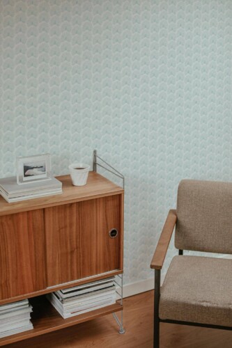 Mid-century style living room decorated with Teal palm leaf peel and stick wallpaper