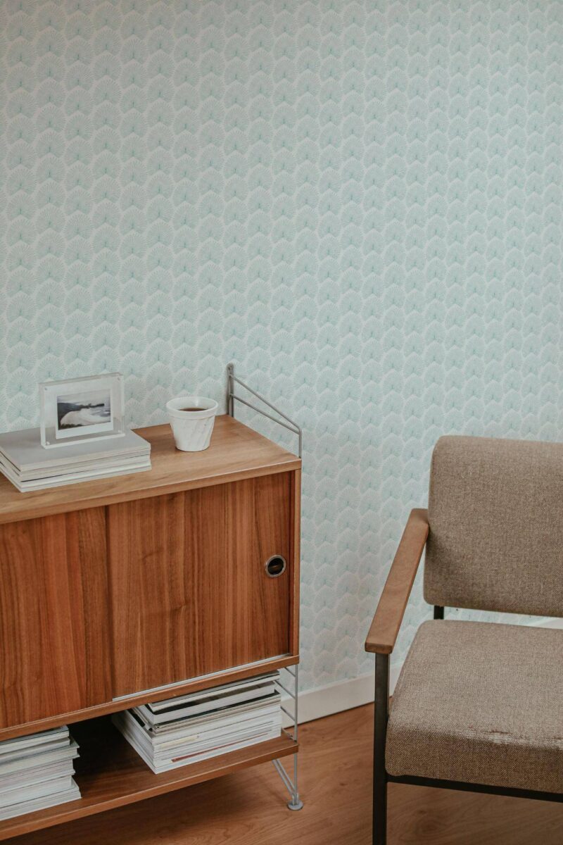 Mid-century style living room decorated with Teal palm leaf peel and stick wallpaper