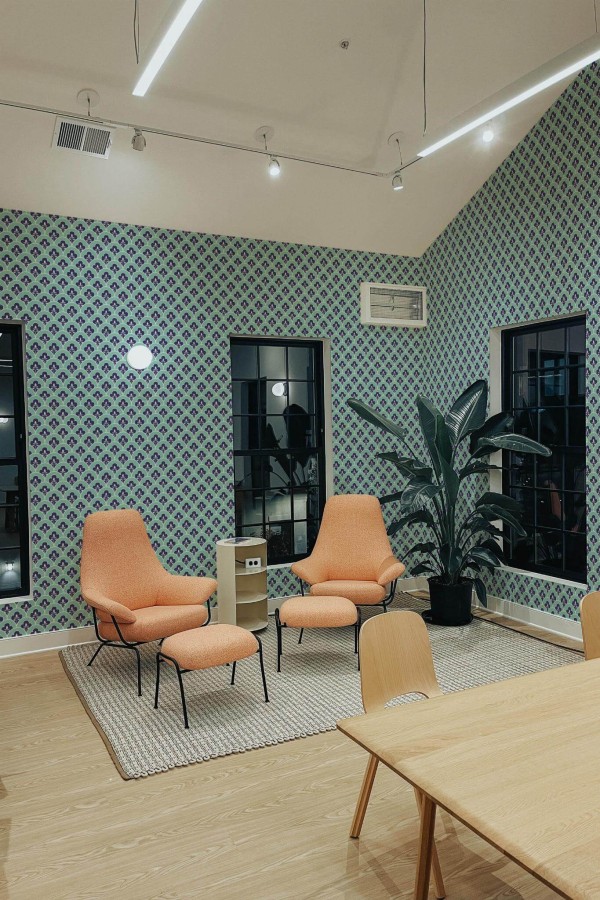 Minimal style living room decorated with Turquoise vintage peel and stick wallpaper and mid-century style chairs