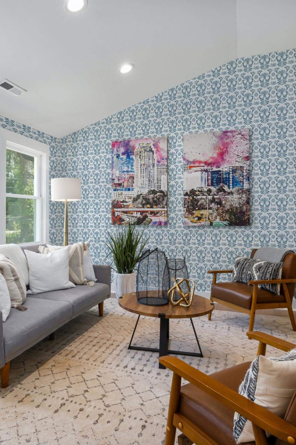 Mid-century modern style living room decorated with Vintage blue damask floral peel and stick wallpaper and colorful funky artwork