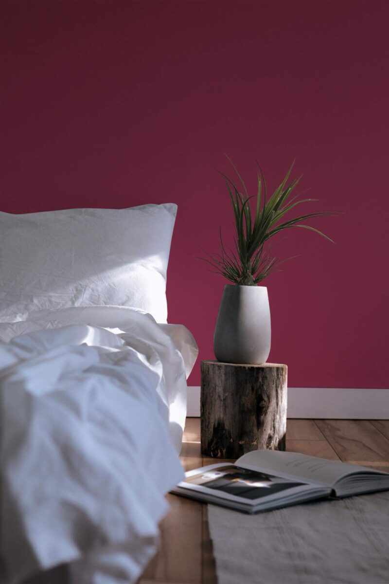 Minimal scandinavian style bedroom decorated with Viva Magenta peel and stick wallpaper