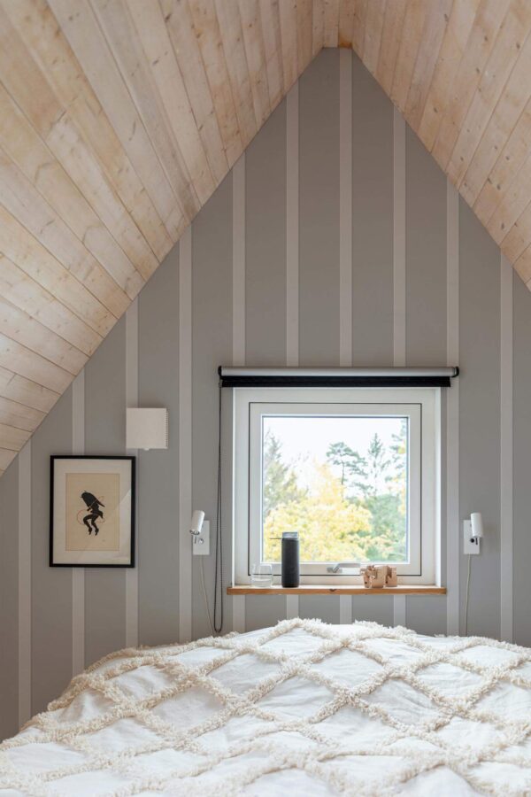 Light farmhouse style bedroom decorated with Wall board effect peel and stick wallpaper