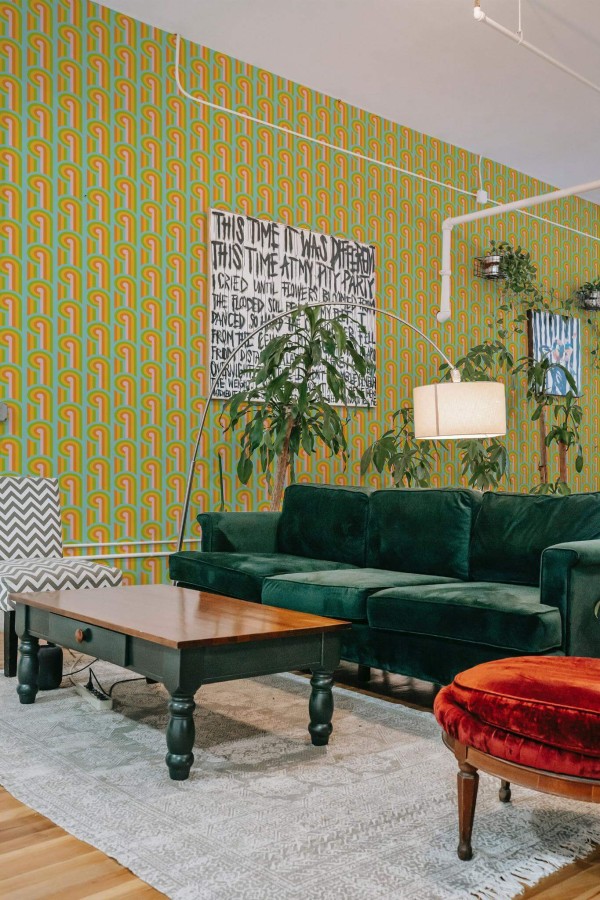 Bold eclectic style living room decorated with Whimsical retro peel and stick wallpaper and emerald green sofa