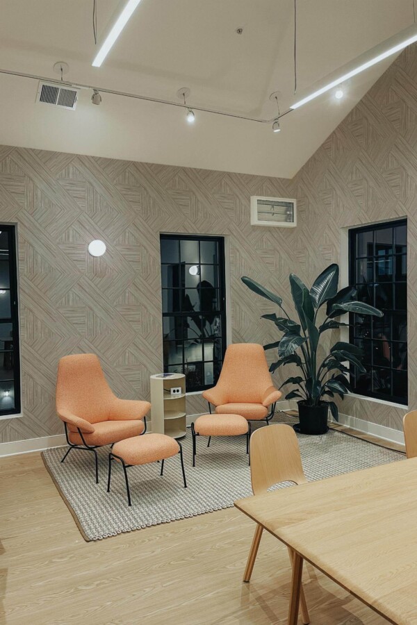 Minimal style living room decorated with Wood tile peel and stick wallpaper and mid-century style chairs