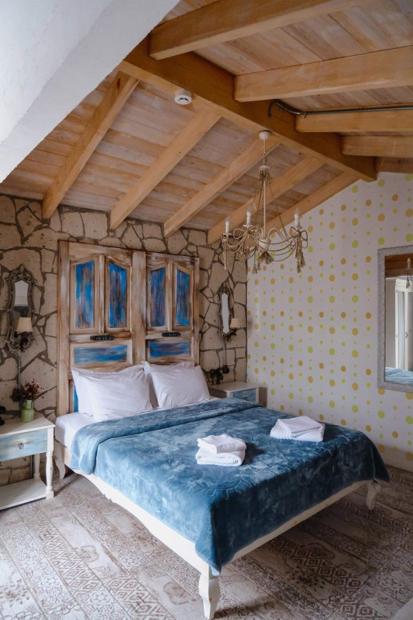 Farmhouse style bedroom decorated with Yellow dot peel and stick wallpaper