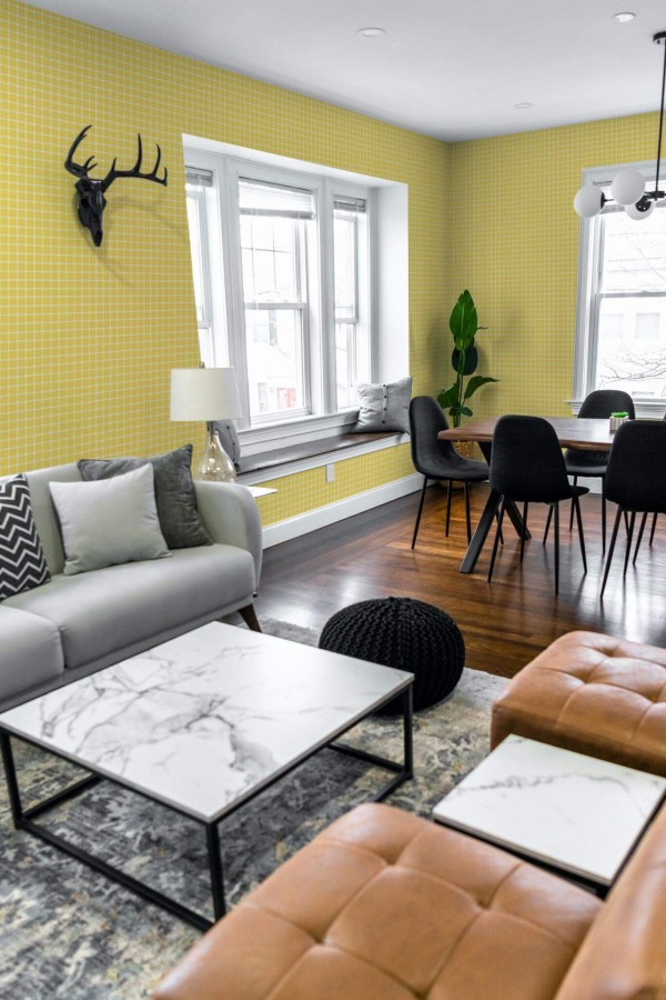 Mid-century modern scandinavian style living dining room decorated with Yellow gingham peel and stick wallpaper