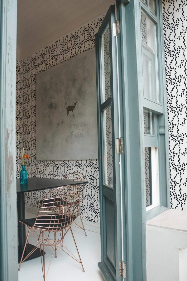 Minimal coastal style cafe decorated with Abstract lines and spots peel and stick wallpaper