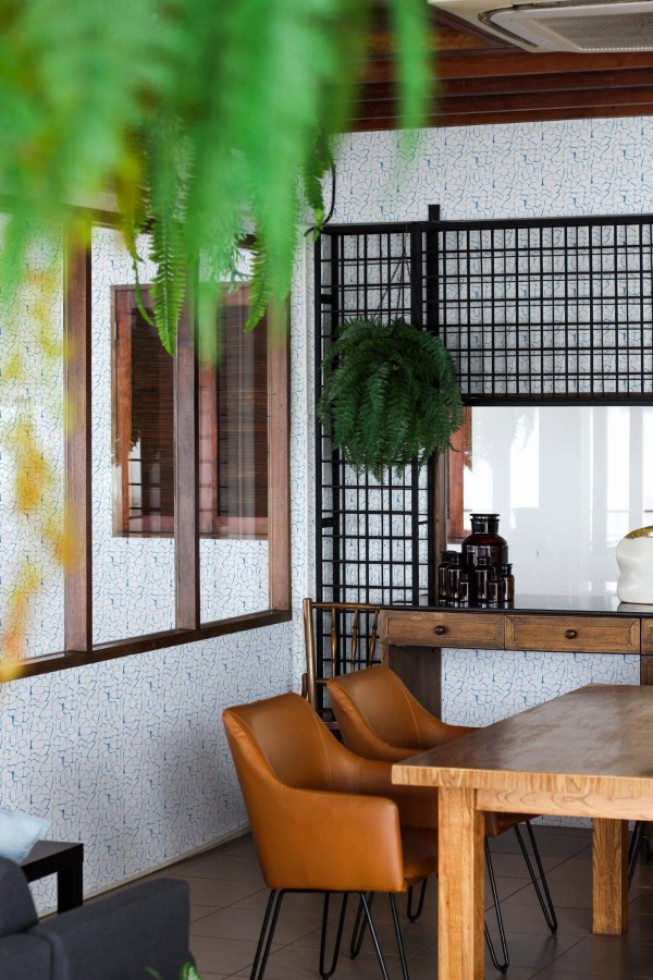 Mid-century modern style dining room decorated with Abstract peel and stick wallpaper and black industrial accents
