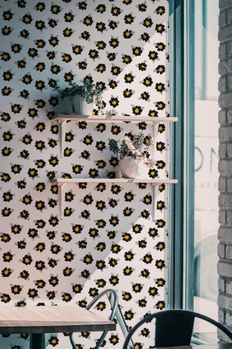 Industrial style cafe decorated with Black and white floral peel and stick wallpaper