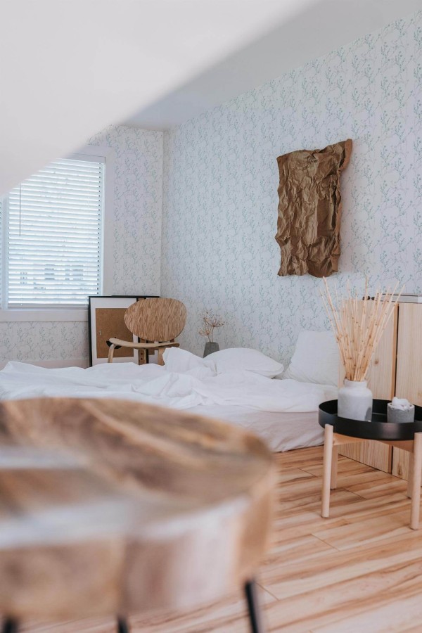 Boho style bedroom decorated with Blue and gray wildflower peel and stick wallpaper