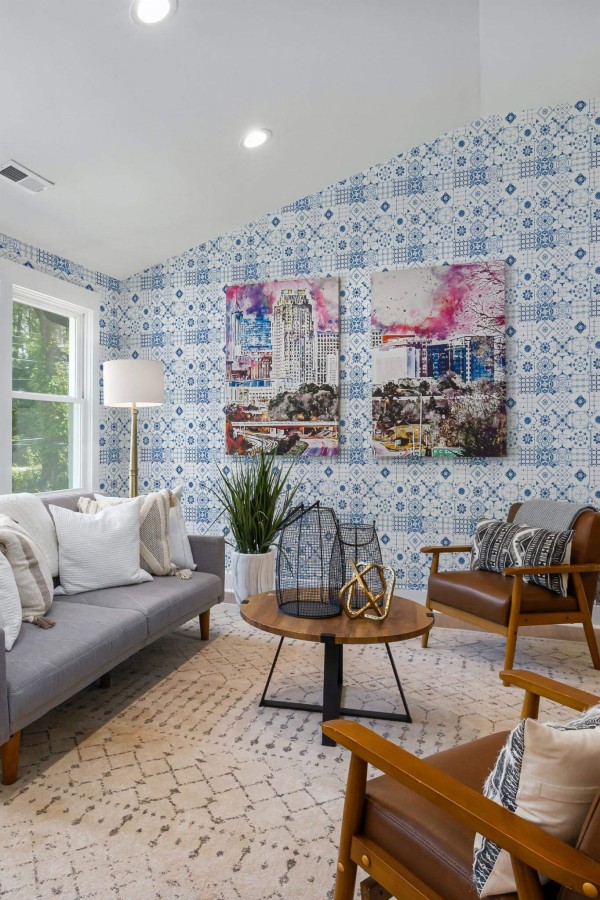 Mid-century modern style living room decorated with Blue Mediterranean Tile peel and stick wallpaper and colorful funky artwork