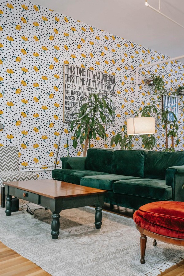Bold eclectic style living room decorated with Bold floral peel and stick wallpaper and emerald green sofa