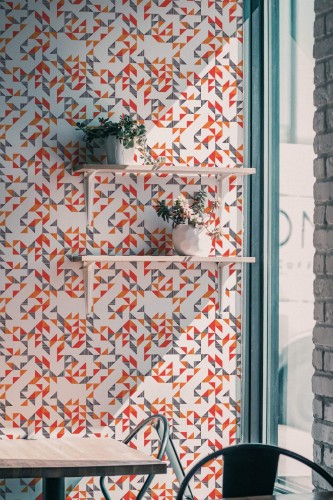 Industrial style cafe decorated with Bold geometric triangle peel and stick wallpaper