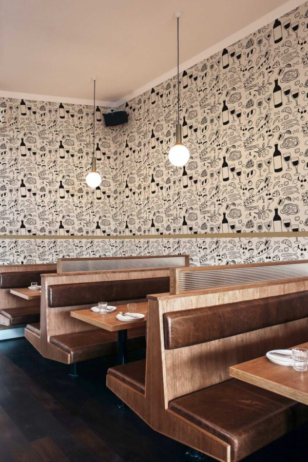 Self-adhesive wallpaper featuring wine and croissant doodles by Fancy Walls