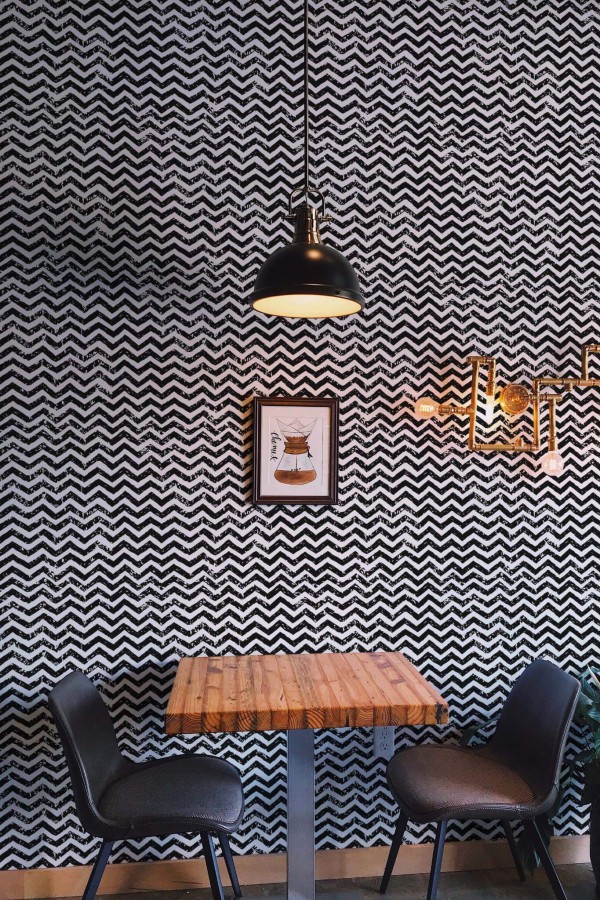 Rustic farmhouse style dining room decorated with Brush stroke chevron peel and stick wallpaper