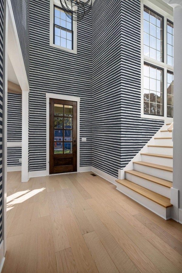 Minimal style entryway decorated with Brush stroke striped peel and stick wallpaper