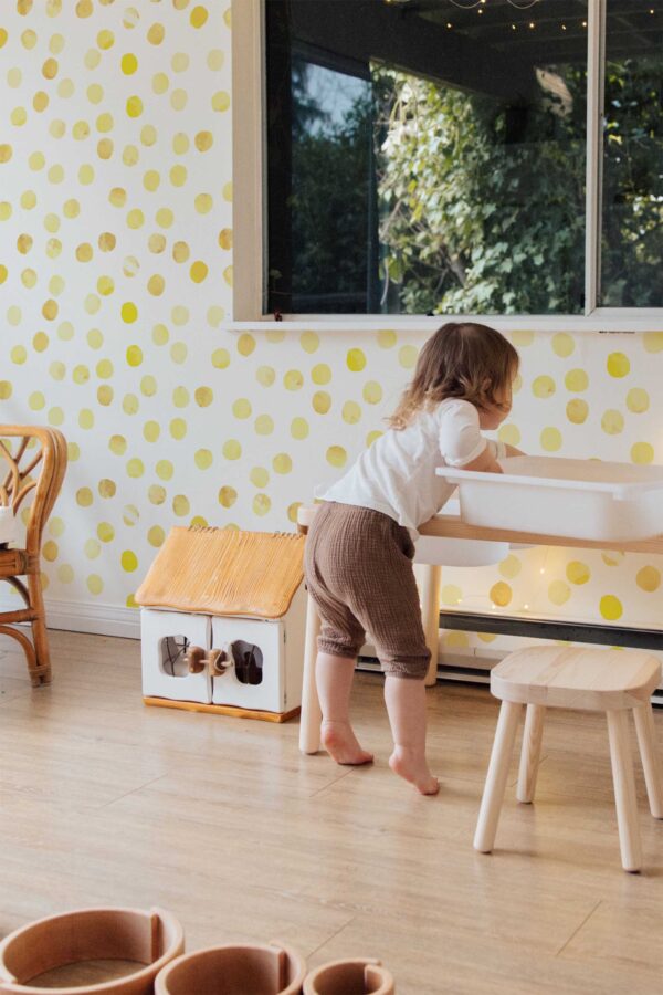 Fancy Walls peel and stick wallpaper with cheerful yellow polka dots